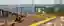 This architectural rendering showcases a modern waterfront pier and deck design. The space features 