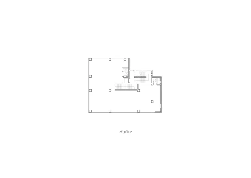 Floor plan drawing of the office level showing open workspace and a service core with stairs