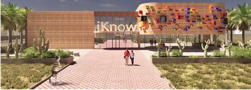 The entrance pathway to the iKnow Library, surrounded by native landscaping that complements the desert environment.