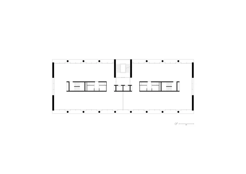 Upper floor plan drawing showing a long rectangular layout with central circulation and columns