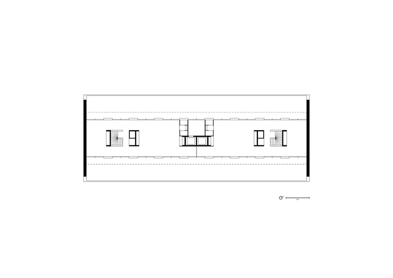 Upper floor plan drawing showing a long rectangular layout with central circulation and columns