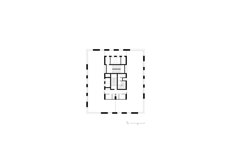 Floor plan drawing showing a rectangular building with central stair core and symmetrical room layout