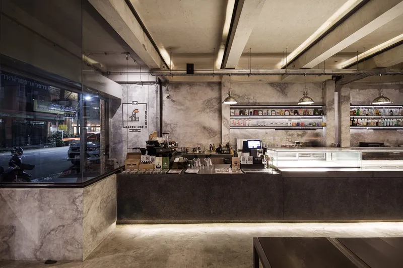 Upper floor restaurant: warm timber slatted ceiling, stone counter bar with stools, paper lanterns, timber furniture
