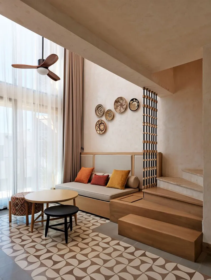 Sunken lounge with timber steps and geometric tile floor beneath a concrete coffered ceiling