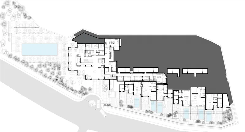 Ground floor plan drawing showing room layouts, courtyards, pools, and terraced site edge with landscape buffer