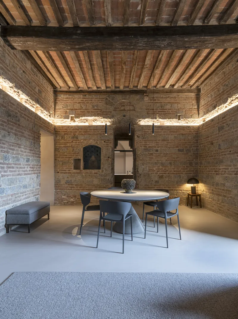 Dining room with exposed brick walls, timber joist ceiling and perimeter cove lighting