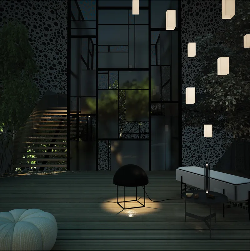 Night terrace with perforated organic screen walls, suspended paper lanterns, timber decking, a knitted pouf, and a glowing floor lamp among the trees