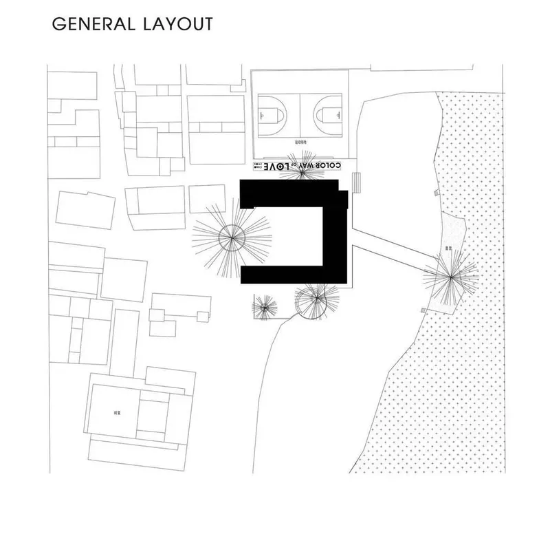 Site plan drawing showing an L-shaped building volume amid surrounding structures with trees and a textured landscape zone