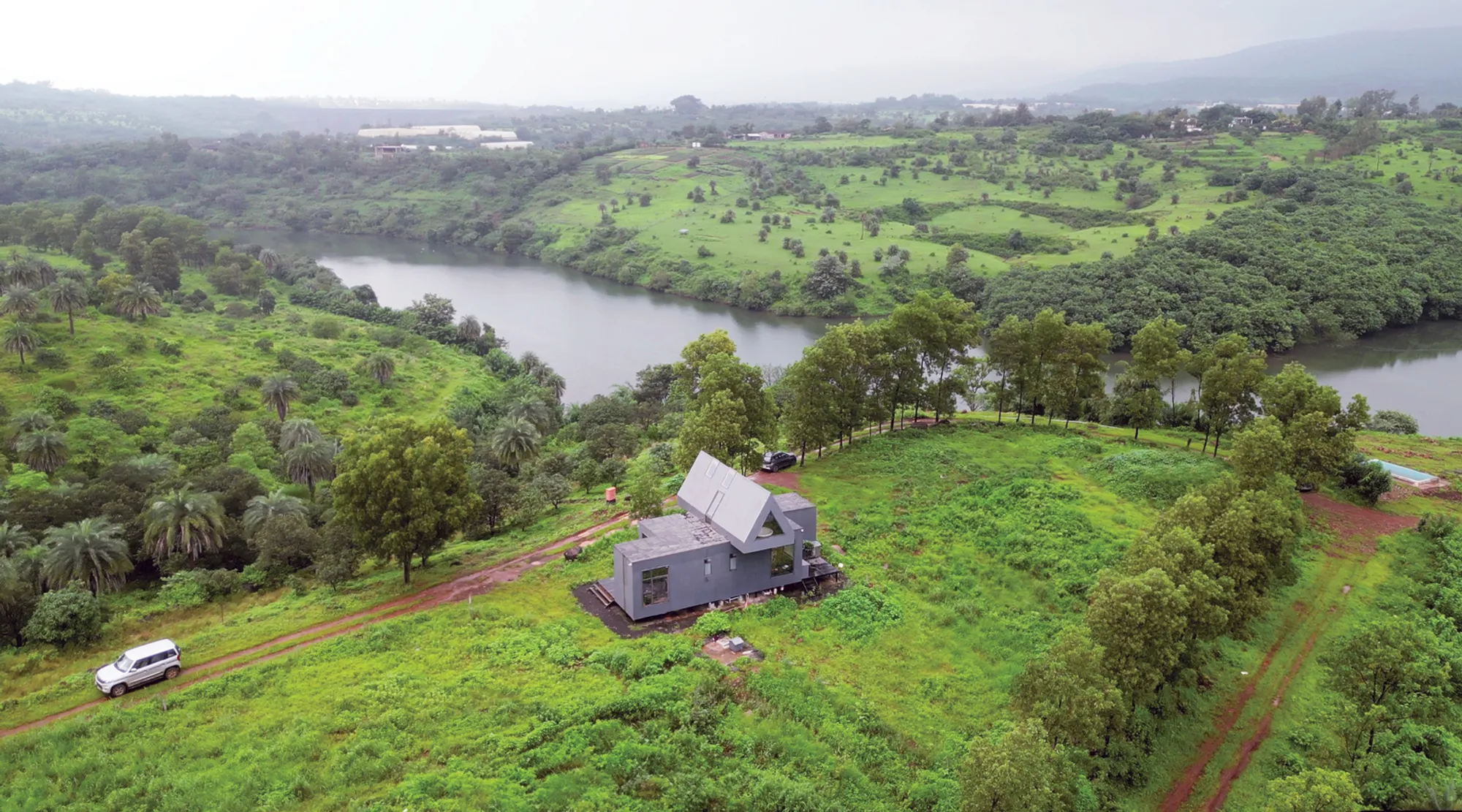 Studio Archohm Plants a Corrugated Metal A-Frame on an Indian Hilltop Overlooking the Ganges