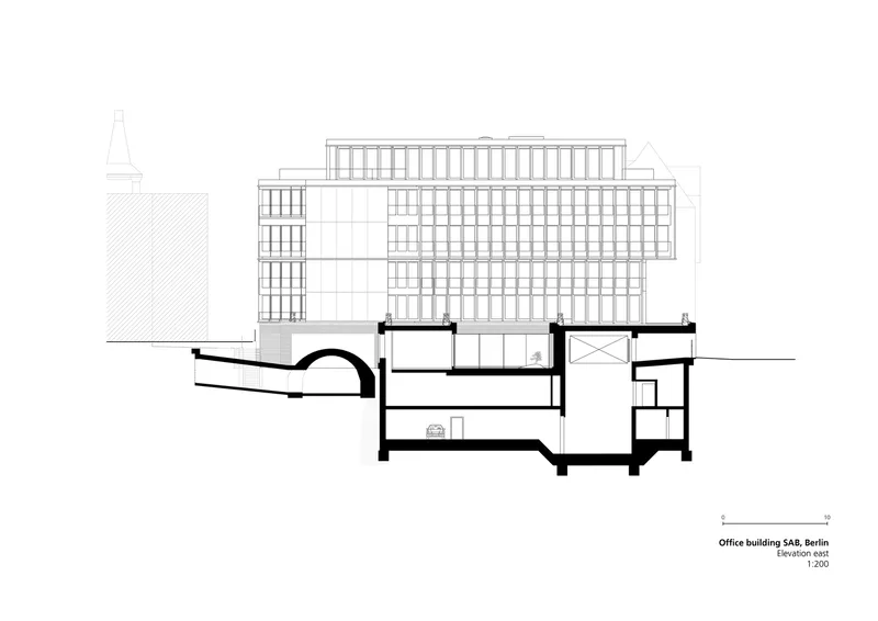 Section drawing revealing underground vaulted spaces beneath a multi-story glass facade tower