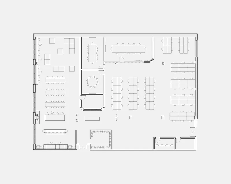 Floor plan drawing showing an open office layout with rows of workstations and small meeting rooms