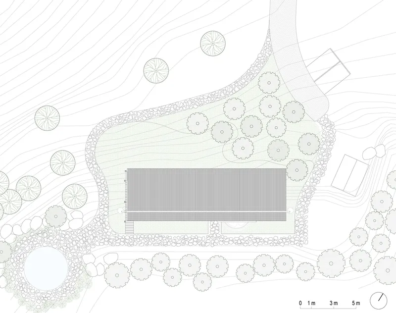 Site plan drawing showing rectangular building footprint surrounded by trees and landscaping contours