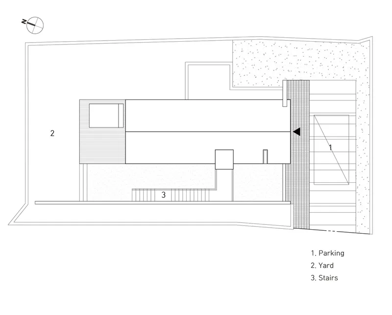 Site plan drawing showing the building footprint with parking, yard, and exterior stair locations