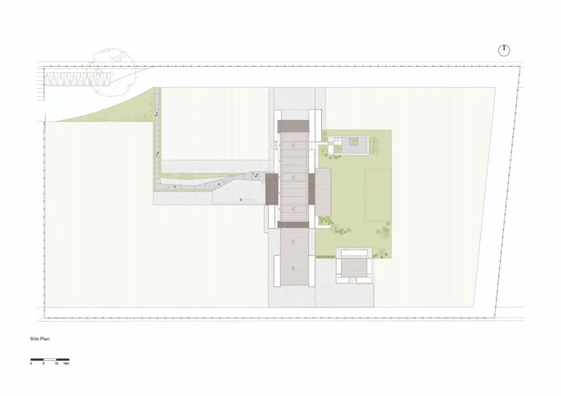 Site plan drawing showing building footprint with adjacent courtyards and access road