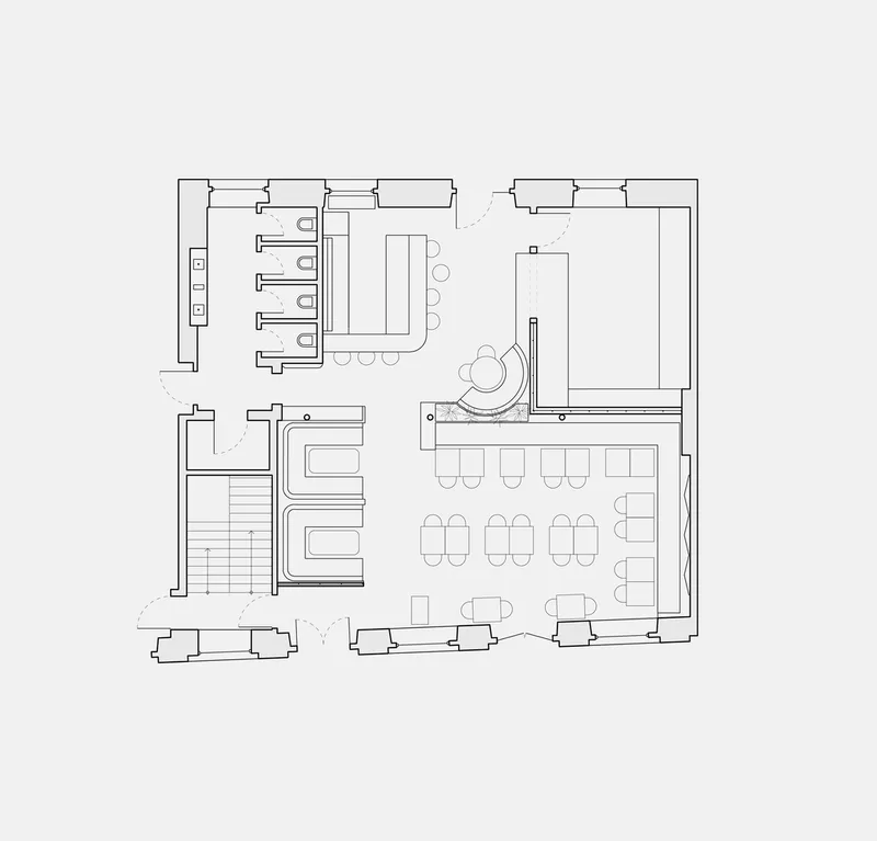 Floor plan drawing showing dining areas, bar seating, restrooms, and staircase in a restaurant layout