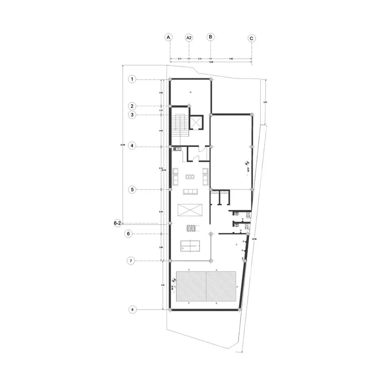 Ground floor plan drawing showing living spaces and a rear courtyard on an angled lot
