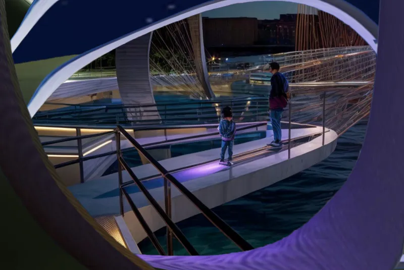 Two figures standing on an observation platform framed by a circular opening at night