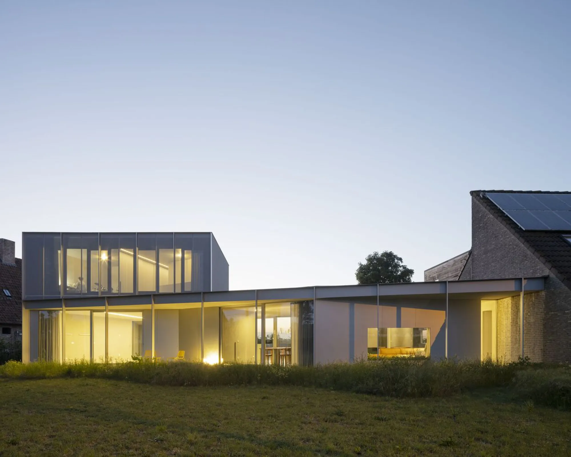 BASIL Architecture Wraps a Belgian Pavilion House in Perforated Metal and Wild Meadow
