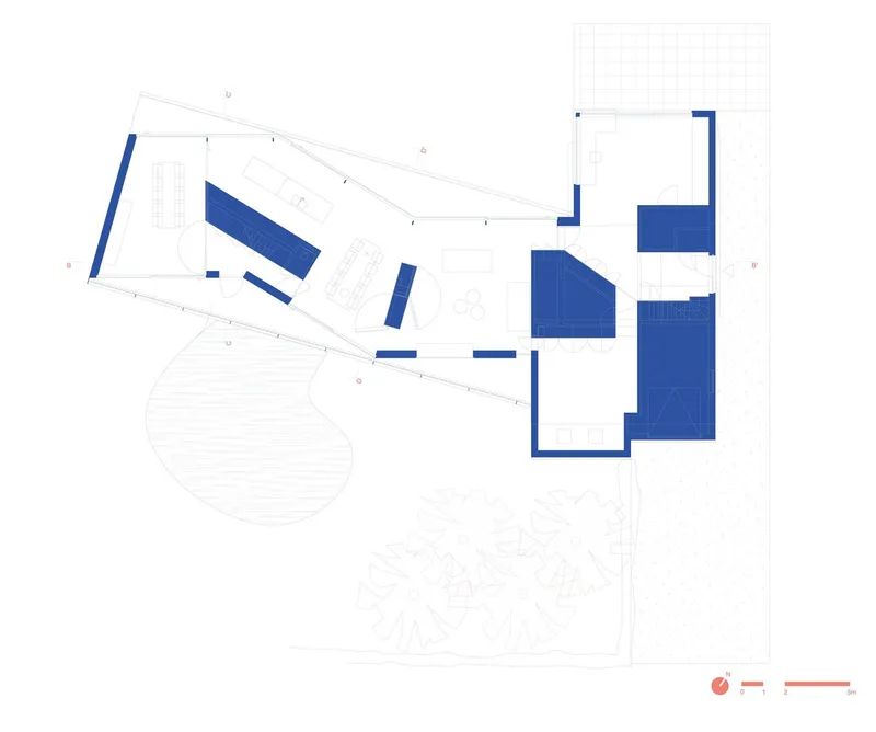 Floor plan drawing showing angular volumes clustered around a curved outdoor area with landscaping
