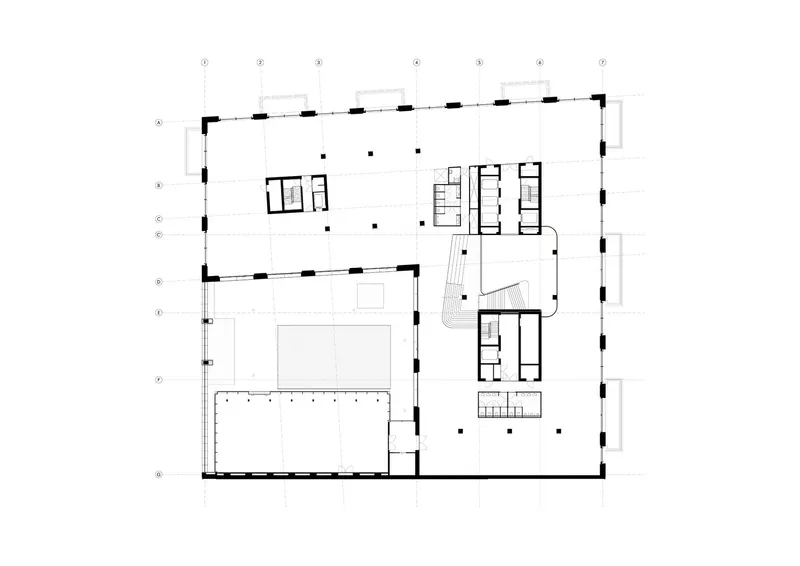 First floor plan showing open space with office clusters and stairwell connecting two wings