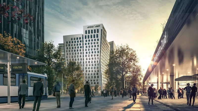Street view of the white tower facade at sunset with pedestrians and a passing tram