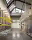 This architectural image showcases the interior of a warehouse or storage facility. The space featur