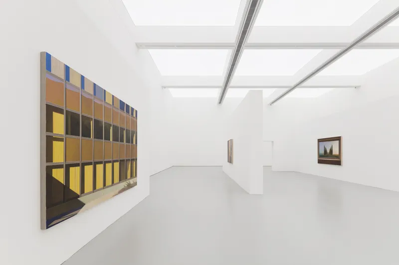 Gallery with painting: large canvas on a white wall, linear skylight above, grey floor, minimal white interior