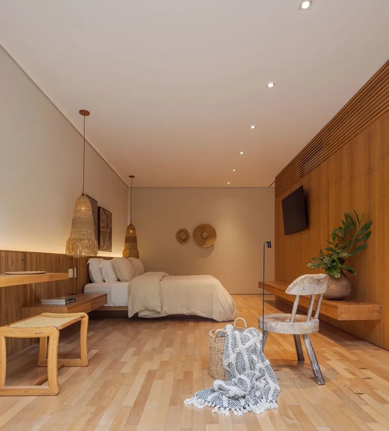Bedroom interior with timber wall panels, woven pendant lights and parquet wood flooring at dusk