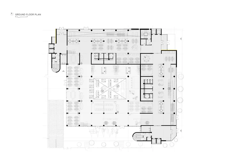 Ground floor plan drawing showing open workspaces arranged around a central atrium with crossed circulation