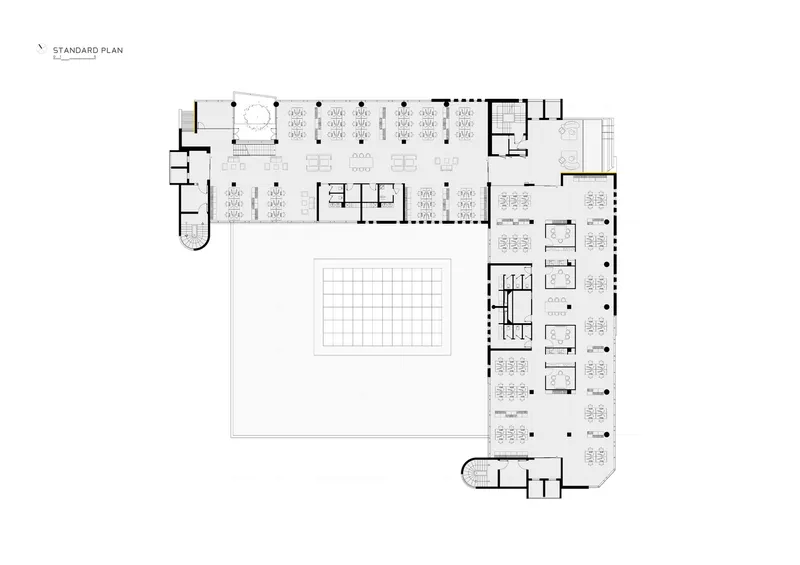 Standard floor plan drawing showing office layouts wrapping a central void with curved corner entry