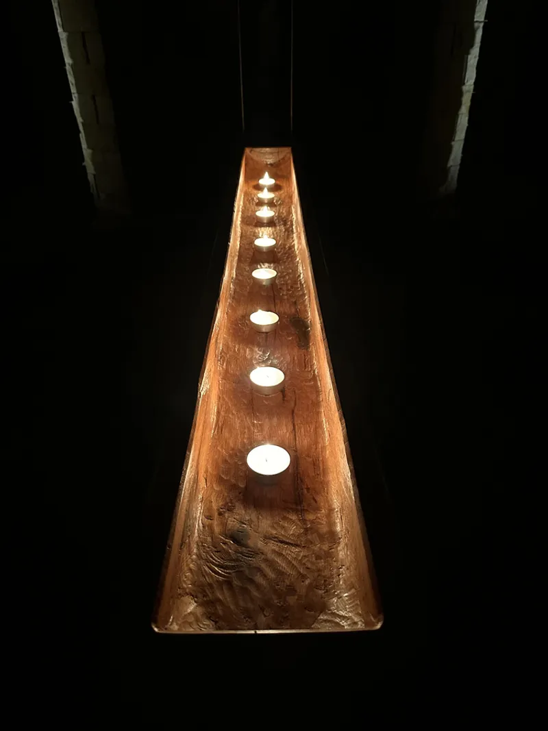 Detail of a hanging copper cone pendant with cut-out lights