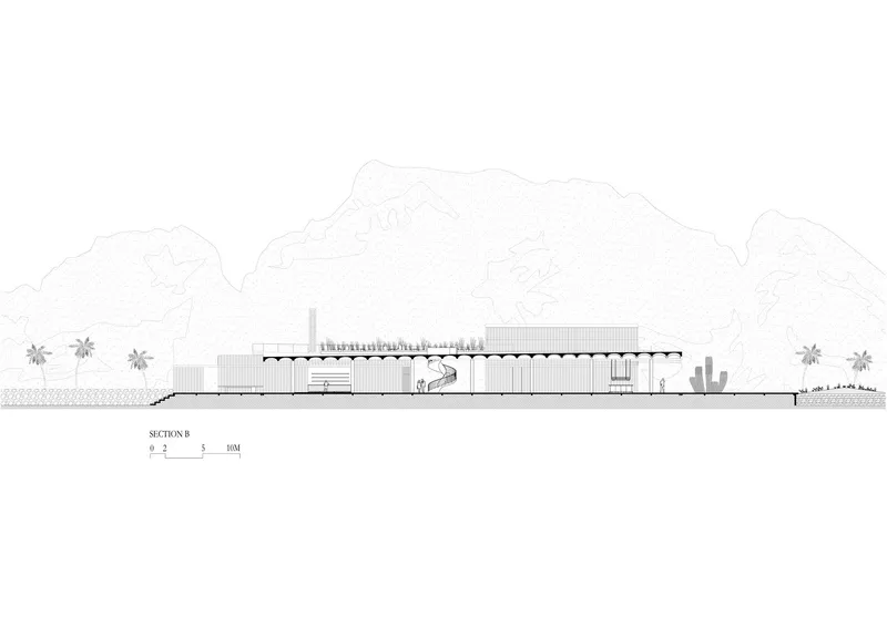 Section drawing showing a low horizontal building with exposed structural trusses and desert landscape with cacti and mountains
