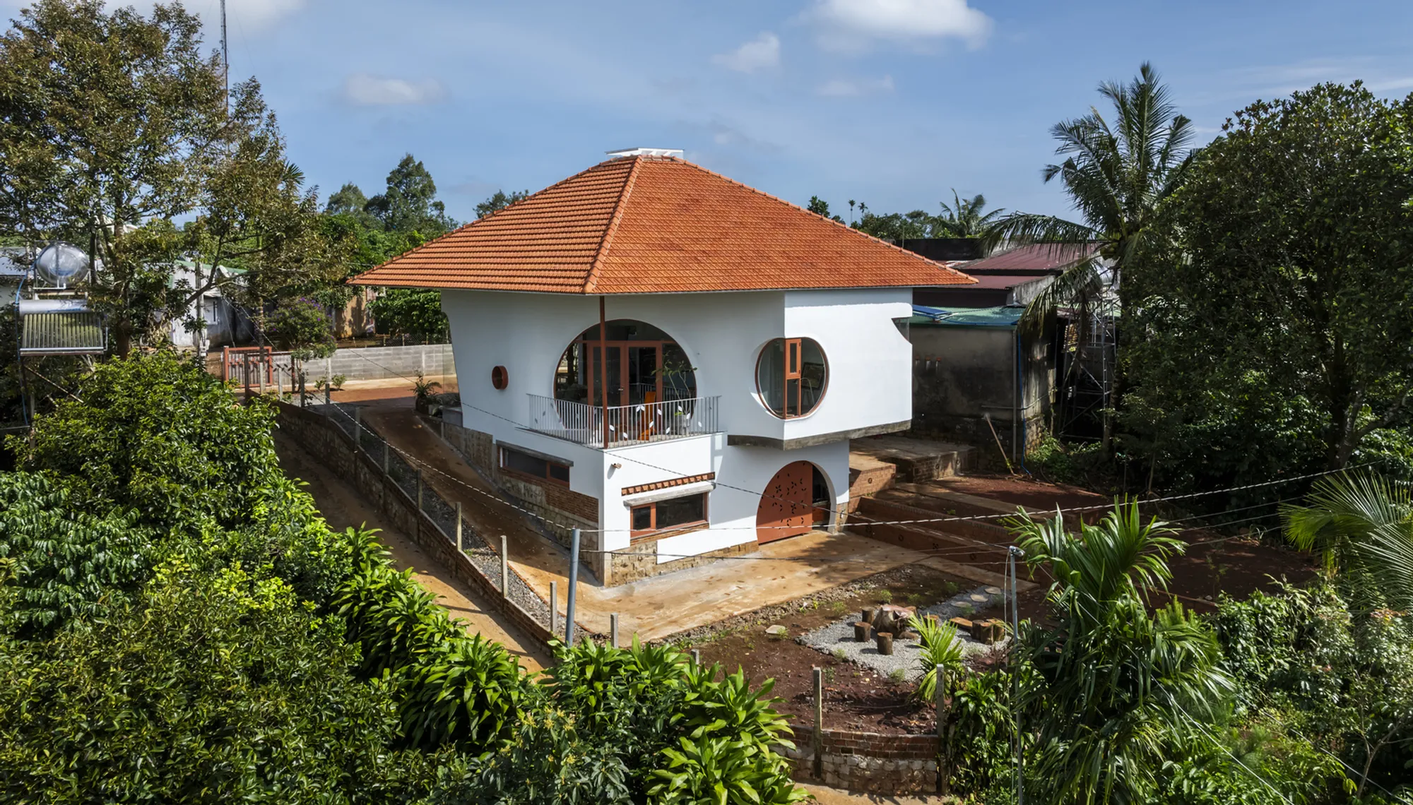 The Bloom Architects Shape a Vietnamese Hillside House Around Circles, Arches, and Morning Fog