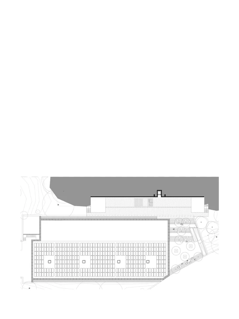 Floor plan drawing showing a long rectangular space with regular column grid and adjacent landscape area