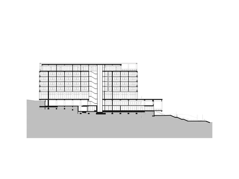 Section drawing revealing two residential towers with underground parking on a sloping site