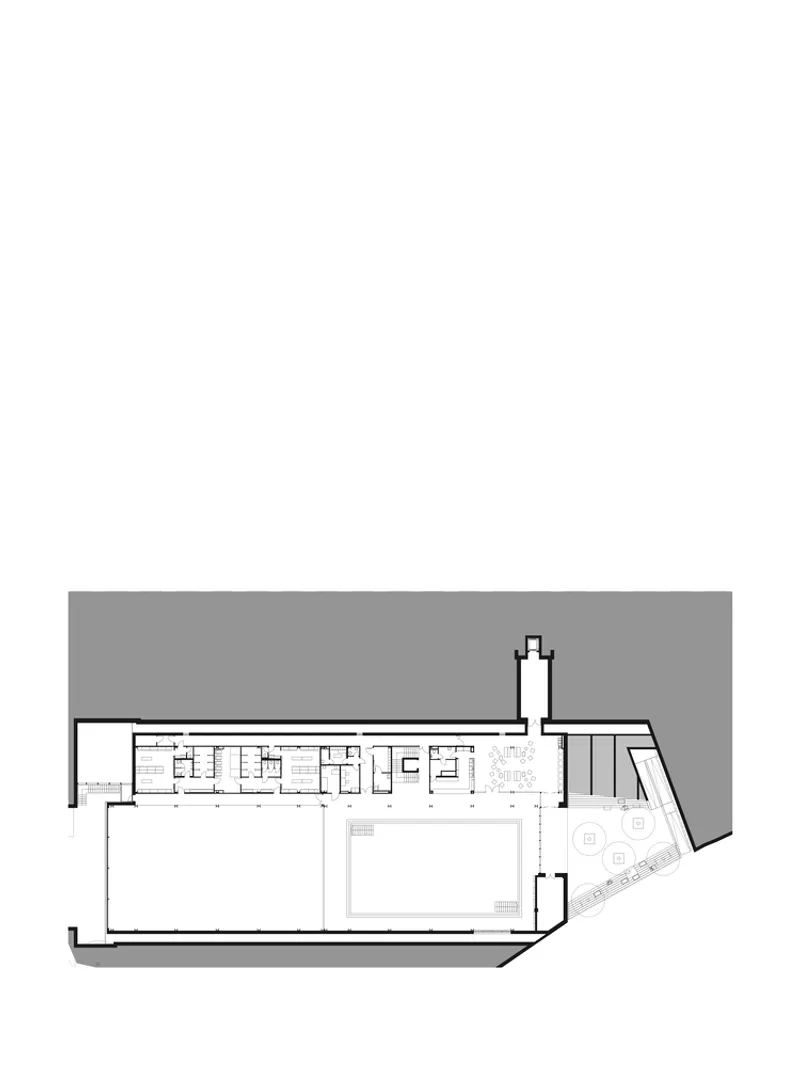 Floor plan showing a swimming pool with angled wing containing changing rooms and rooftop terrace