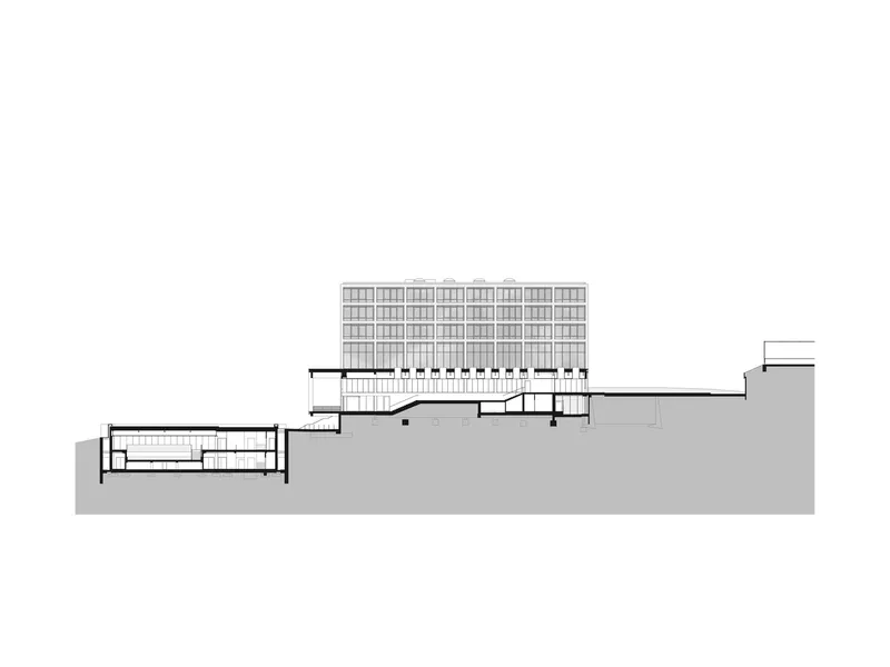 Section drawing showing a residential tower on elevated podium with flanking lower volumes