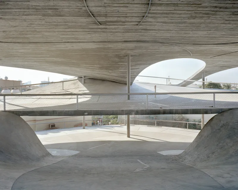 View through the open floor levels showing the stacked roof canopies and mesh safety railings