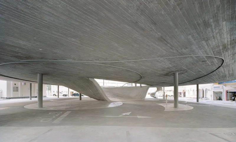 Underside of the ribbed concrete roof slab supported by slender columns over a parking area