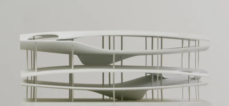Physical model showing two circular levels with slender vertical supports and curved interior volumes