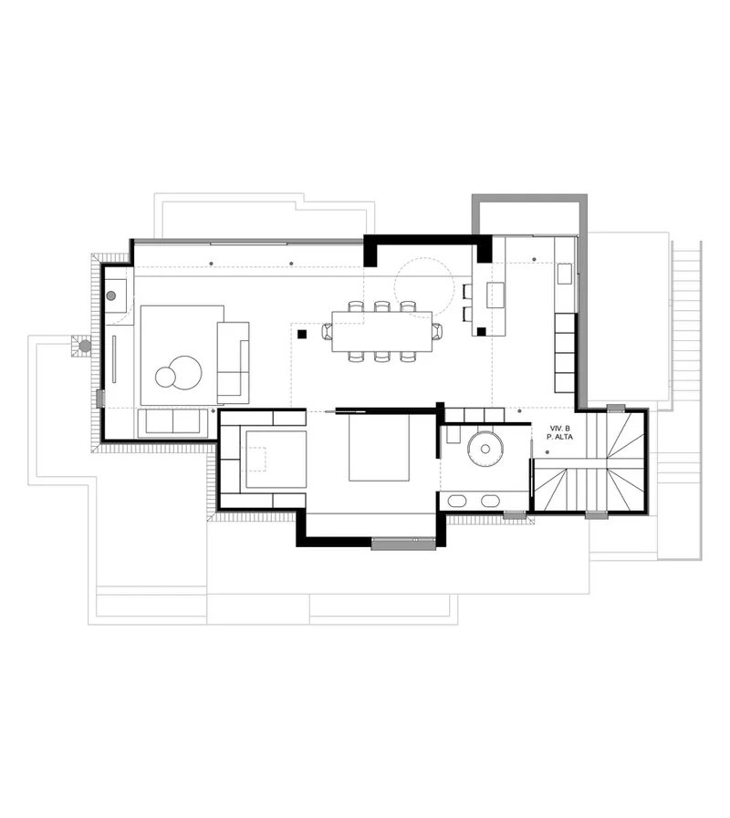 Floor plan drawing showing open living and dining spaces with spiral staircase