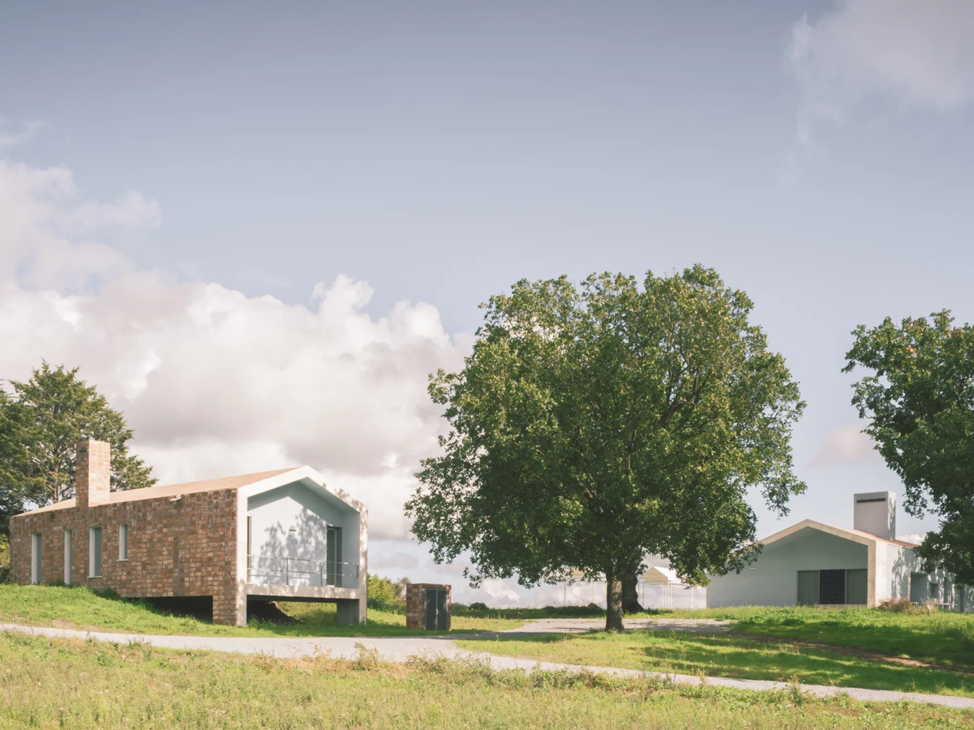 Studio gamp! Scatters a Village of Gabled Volumes Across an Italian Hillside