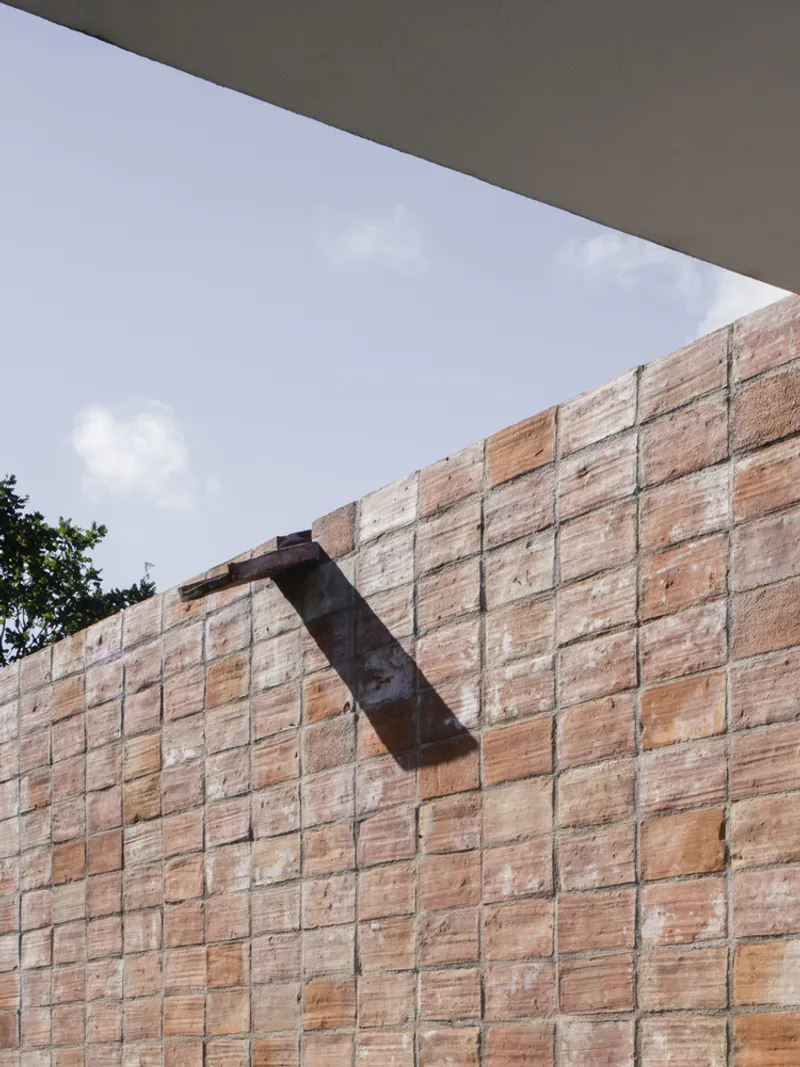 Reclaimed timber formwork wall with metal bracket detail below a concrete soffit