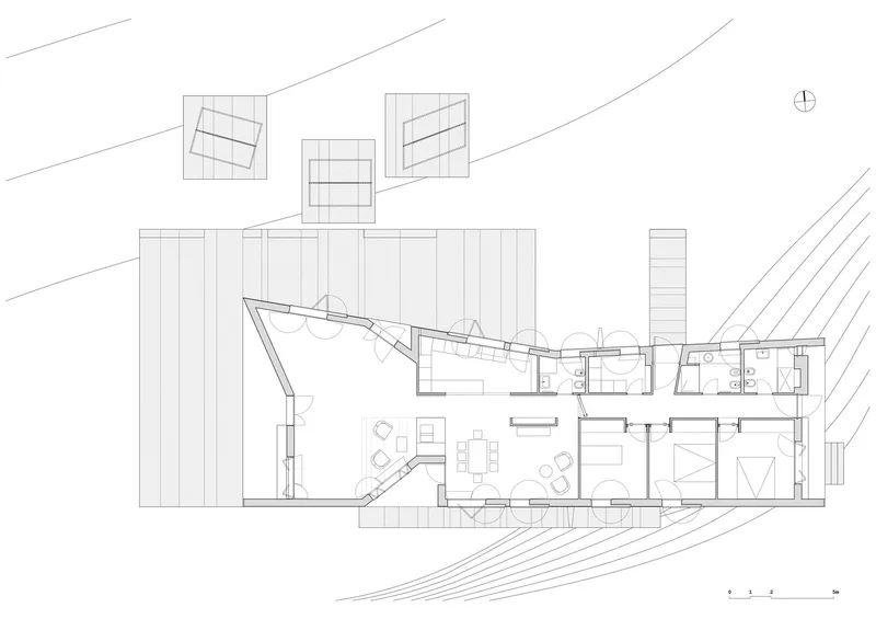 Floor plan drawing depicting angular living area with angled glazing and adjacent bedrooms and bathrooms