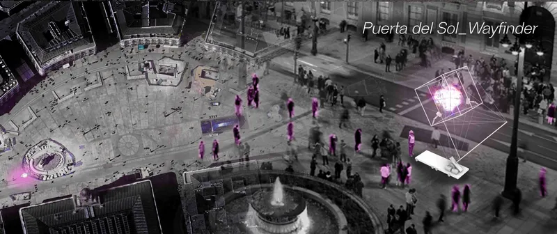 Puerta del Sol, Wayfinder: the tensegrity cube glows on the plaza beside the fountain, casting magenta light over pedestrians in an otherwise monochrome nighttime scene