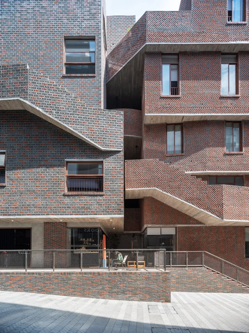Variegated brick facade with openwork screening and curved canopy edges above paved ground level