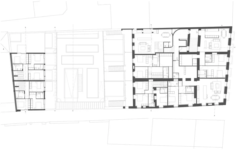 Second floor plan drawing depicting residential units with living spaces and circulation cores