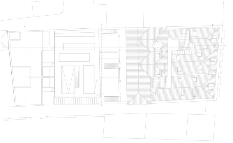 Site plan drawing showing building footprints, a pitched roof volume, and surrounding plots