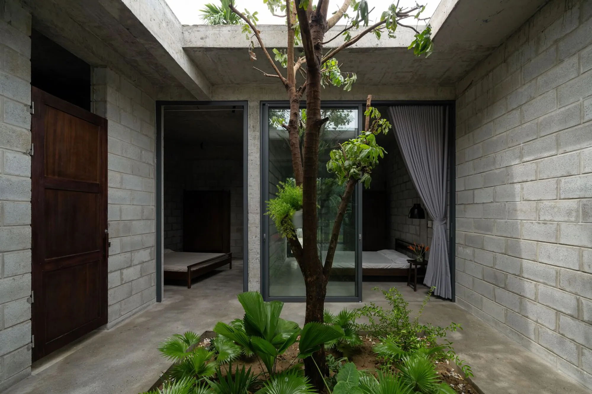 STD Design Consultant Builds a Concrete Block Home Around Living Trees in Vietnam