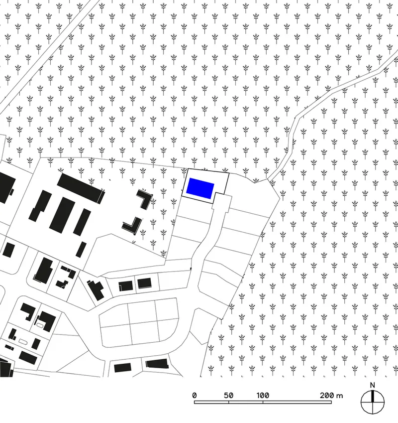 Site plan showing a building highlighted in blue surrounded by tree symbols and road curves